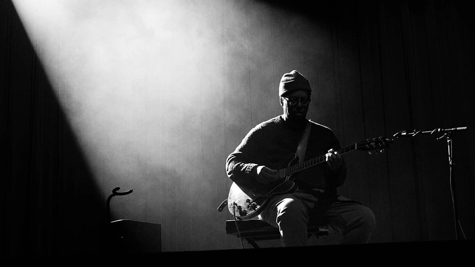 Jeff Parker on a dark stage in the beam of a stage light