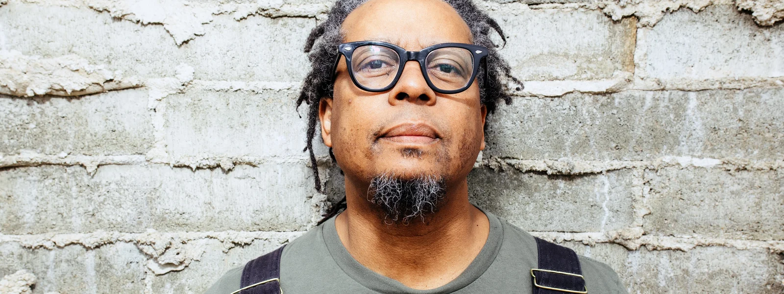 Jeff Parker photographed in front of a brick wall